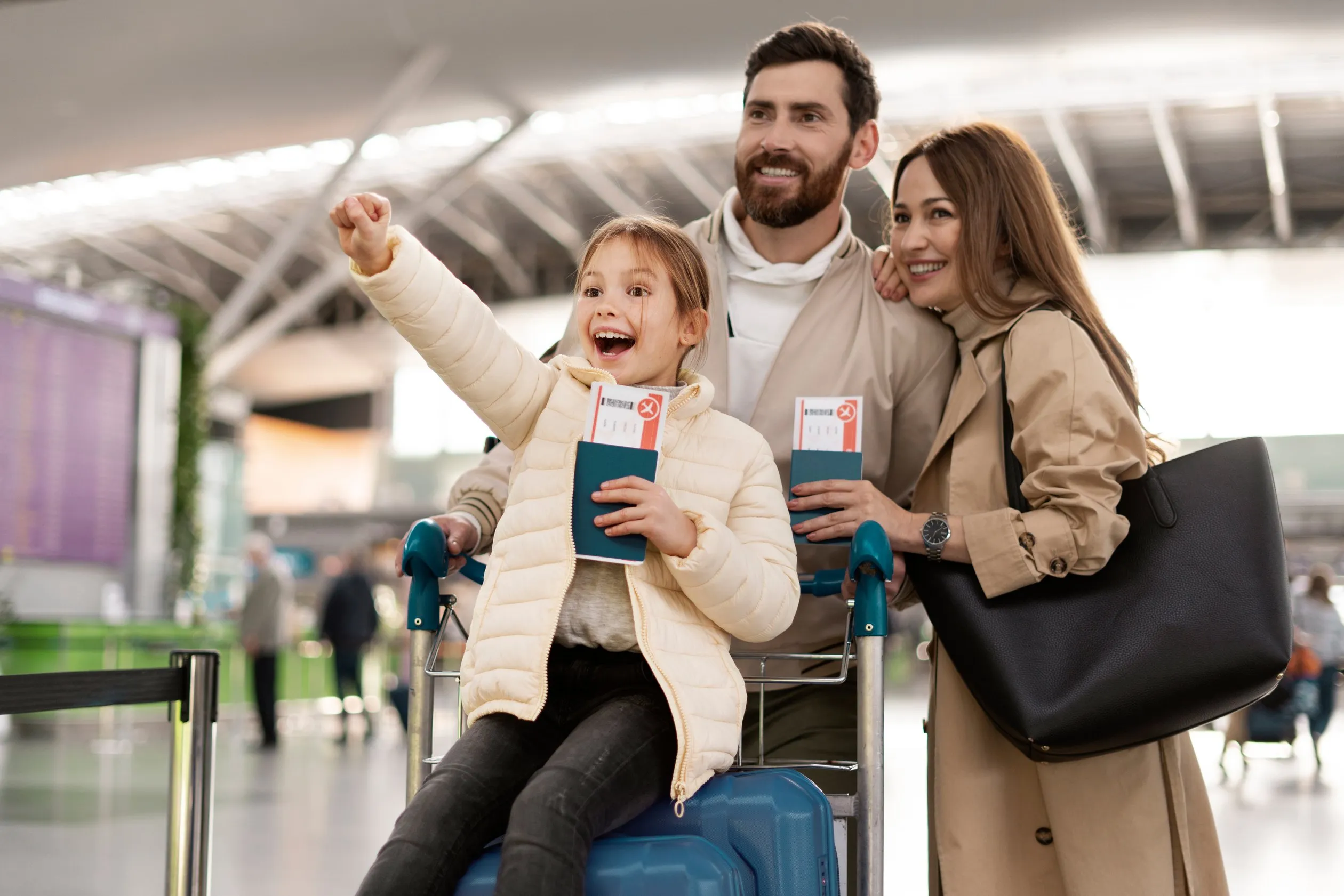 A family with boarding passes celebrating at an airport terminal