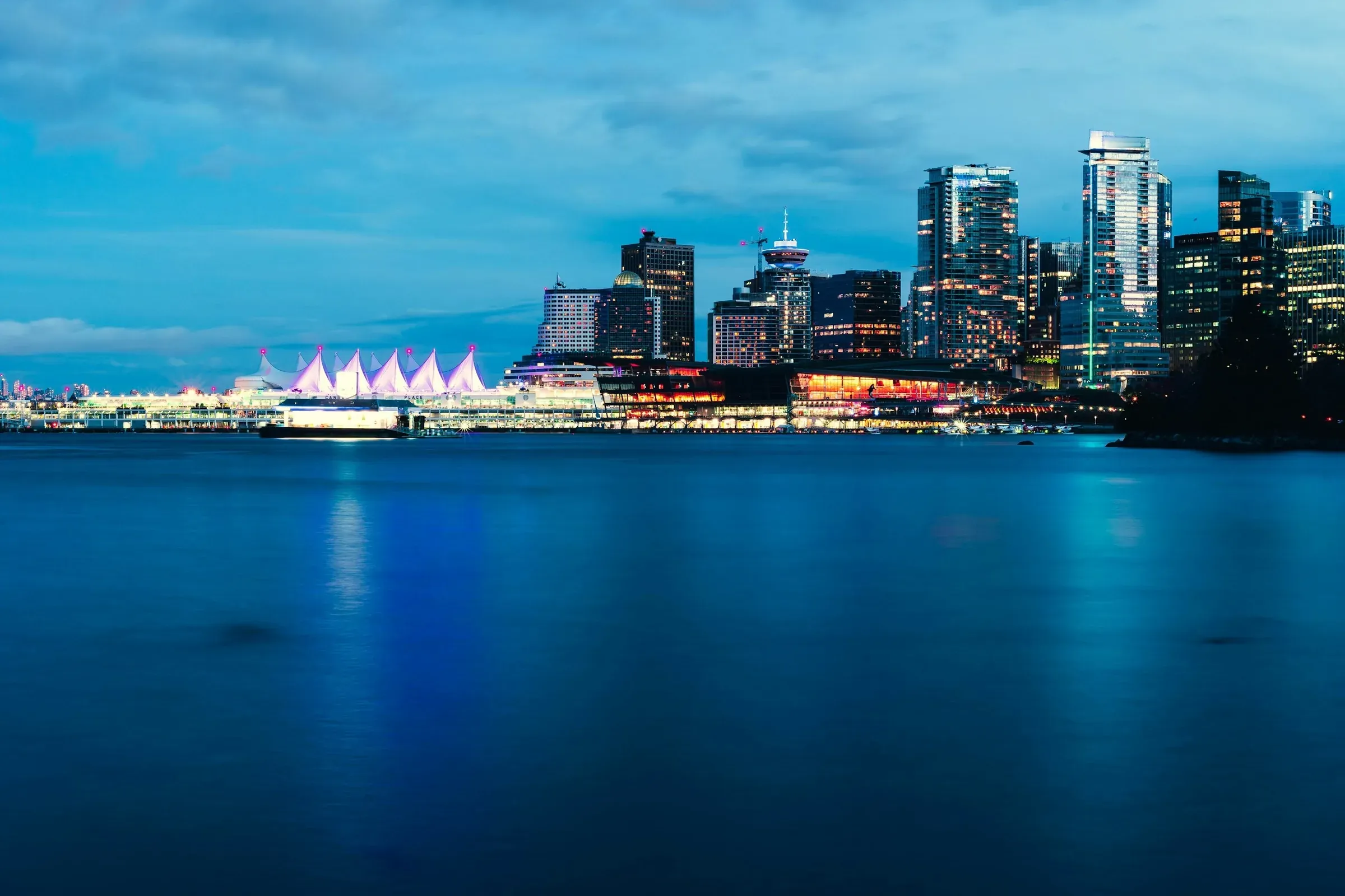 Canada Place and the Vancouver skyline at blue hour, across the harbor