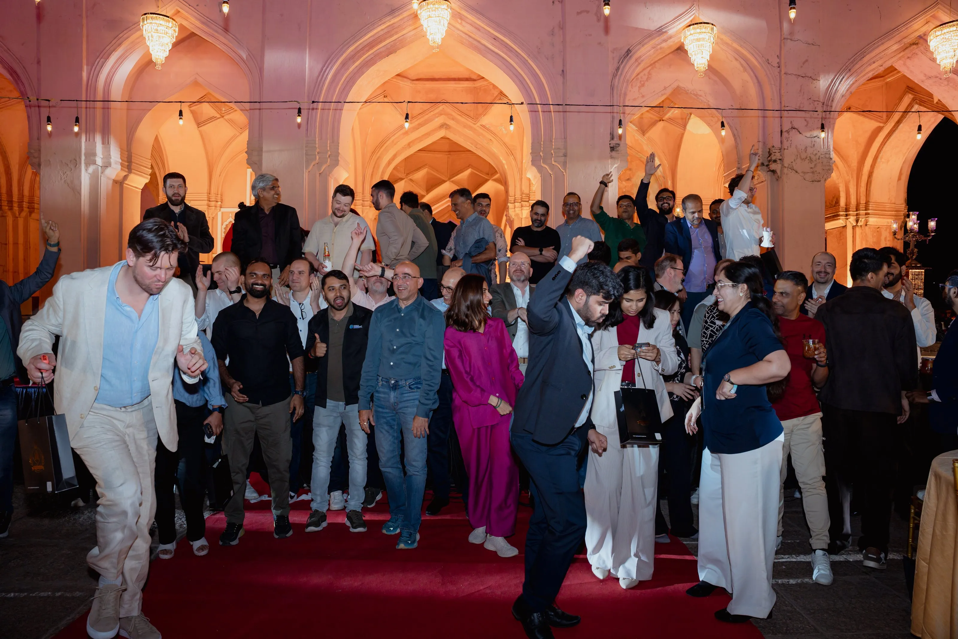 Loyalty Juggernaut team members dancing together at an evening celebration