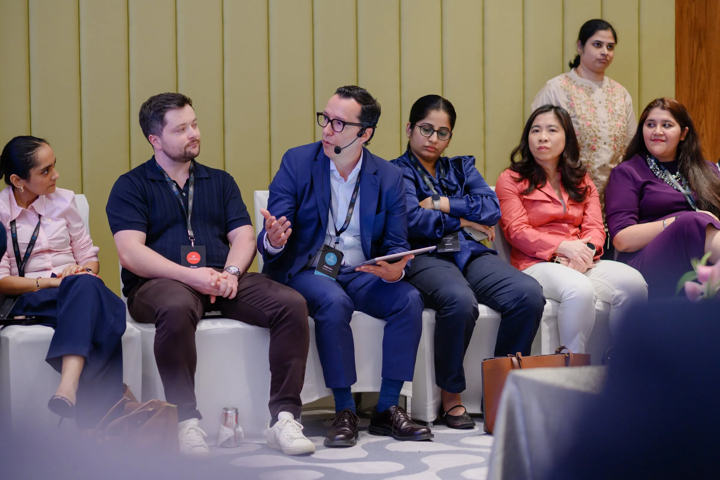 A Loyalty Juggernaut leader speaks during a seated panel session with guests at a company event