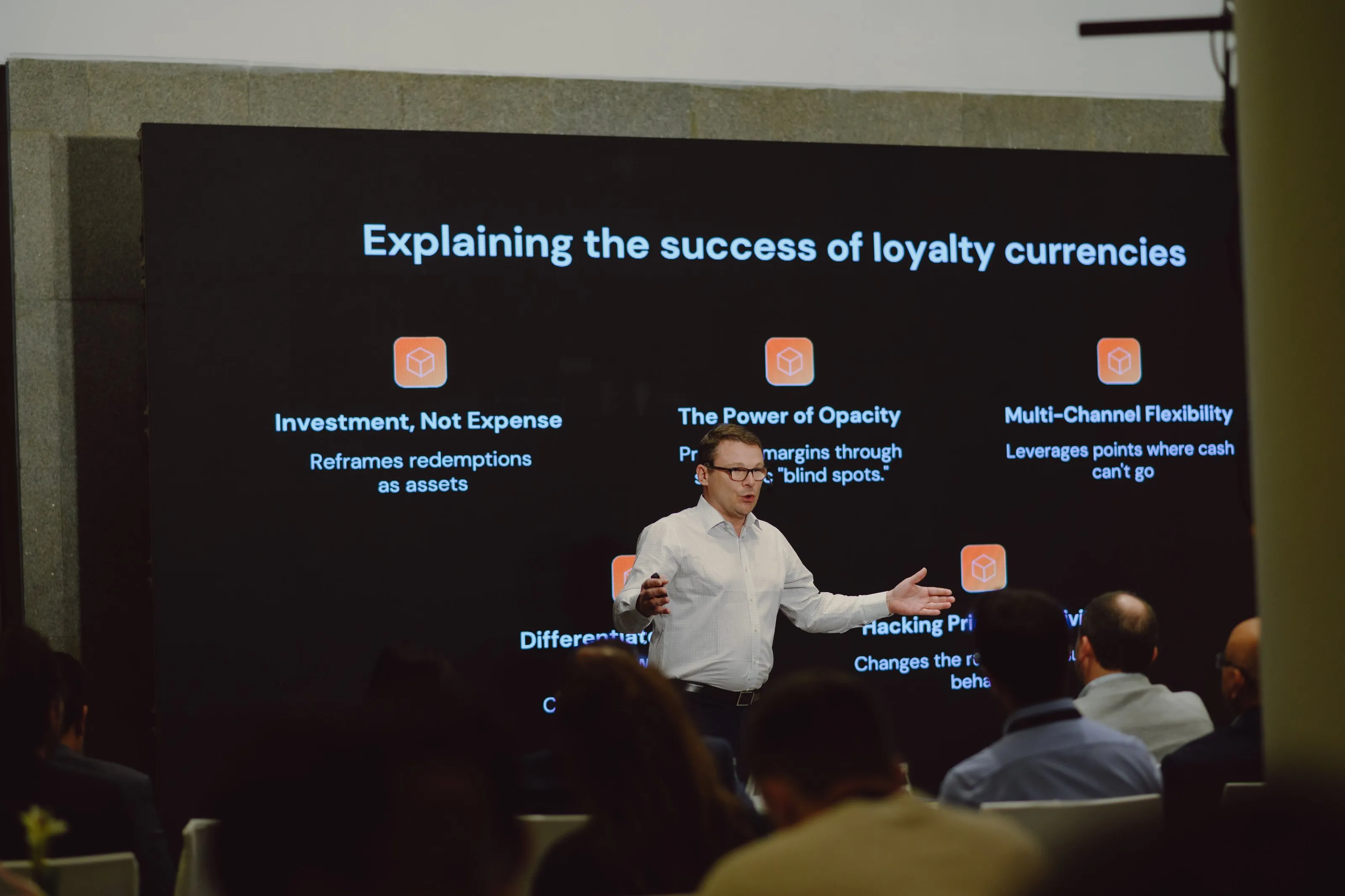 A presenter explaining the success of loyalty currencies at a Loyalty Juggernaut session
