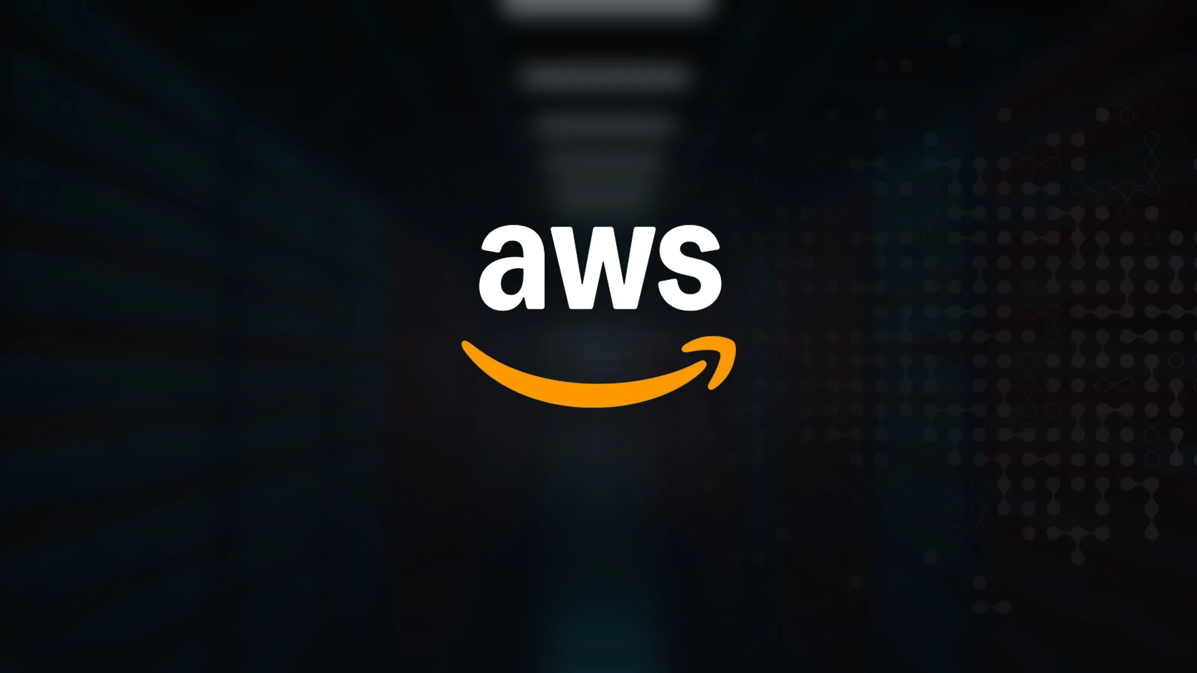The AWS logo over an out-of-focus server hall