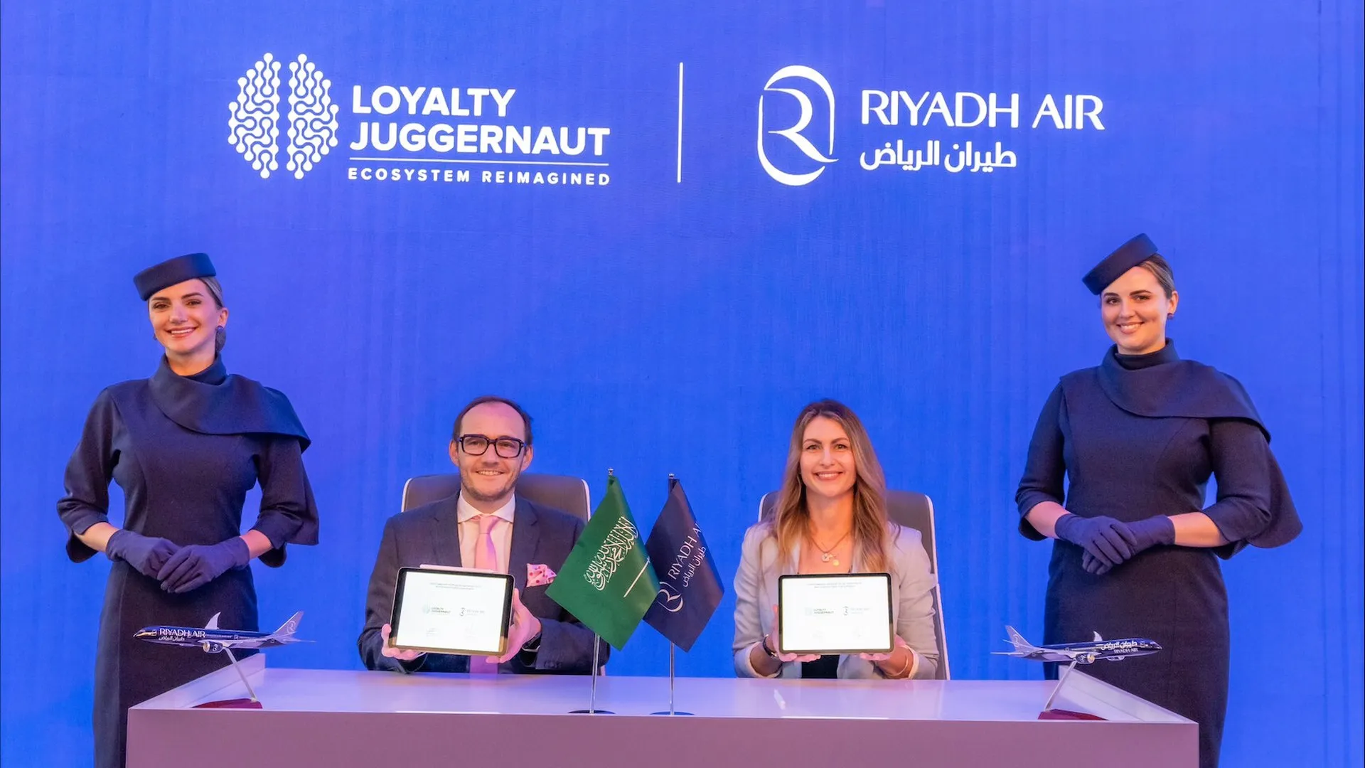 Displaying their commitment to a strategic alliance: James Mulroney, SVP of Client Engagement, Loyalty Juggernaut, and Kim Hardaker, Vice President of Customer Loyalty at Riyadh Air, present their signed agreement. (PRNewsfoto/Loyalty Juggernaut, Inc.)