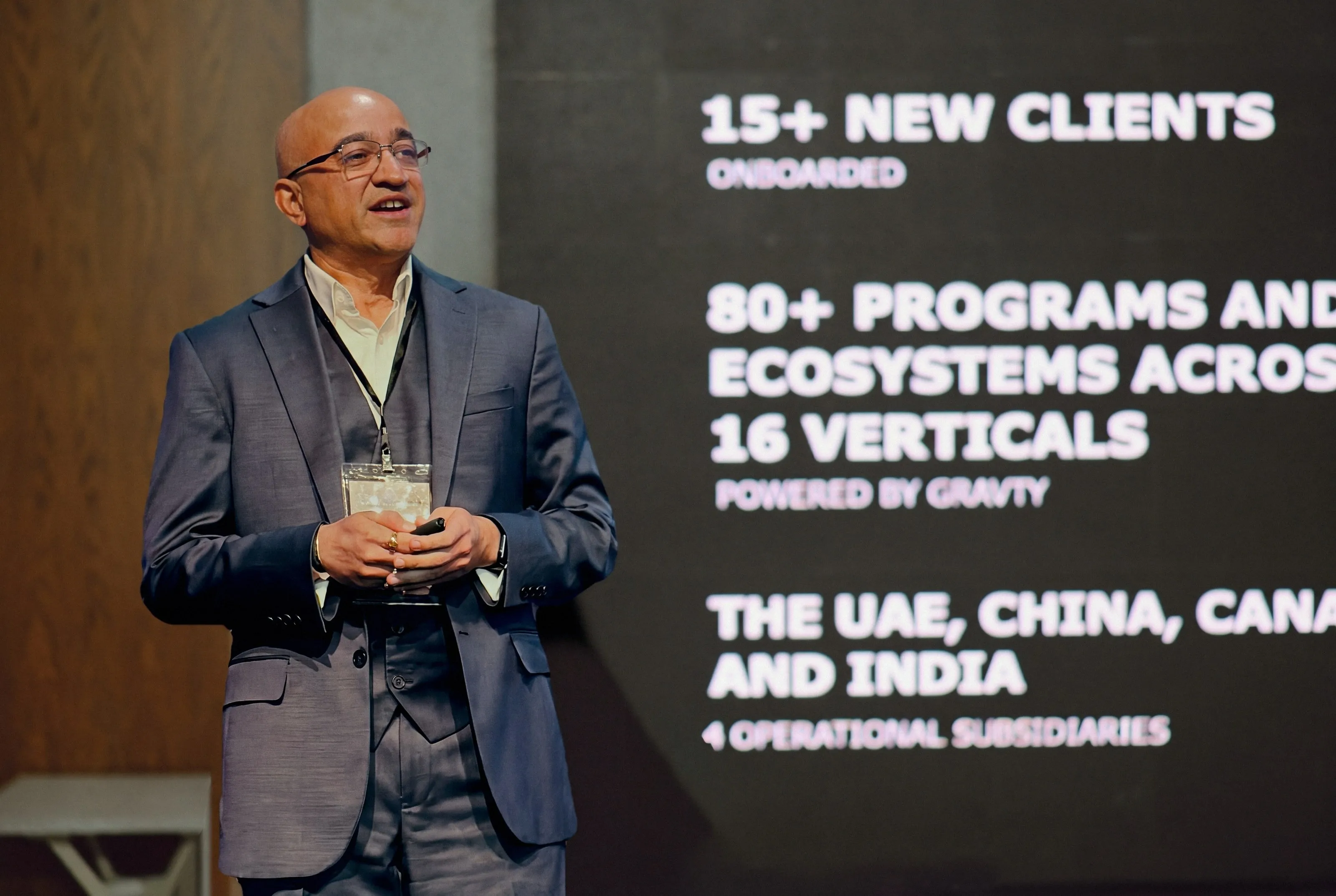 Shyam Shah, co-founder and chief executive of Loyalty Juggernaut, presenting on stage in front of a slide of the company's growth figures